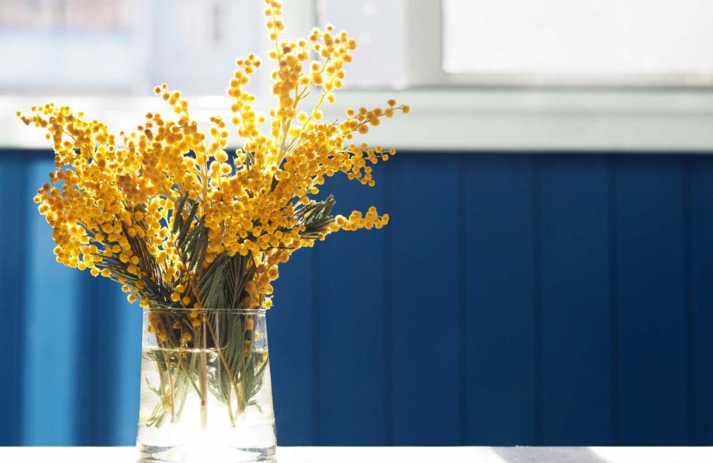 Spring flowers in a vase, on a table.